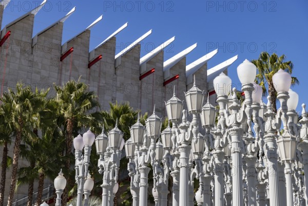 A picture of Urban Light, a public art designed by Chris Burden and unveiled in 2008, next to the Los Angeles County Museum of Art