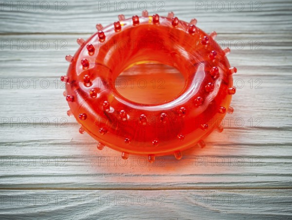 Rubber round hand grip strengthener on wooden board sports training concept