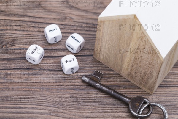 The photo shows a model house with various question cubes and a key