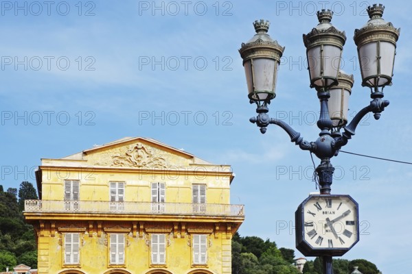 Street lamp with clock in front of the
