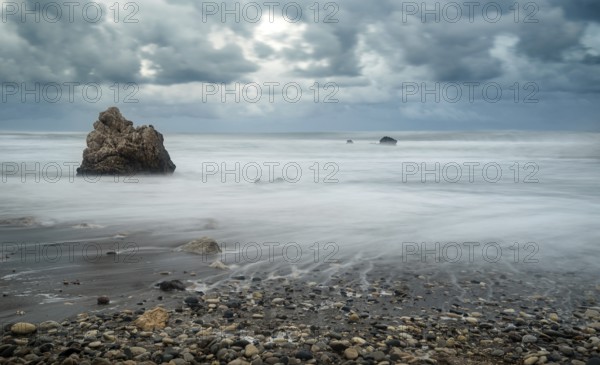 Seascape with windy waves during storm weather at the rocky coastal area of the Rock of Aphrodite in Paphos area, Cyprus. Longexposure Photography