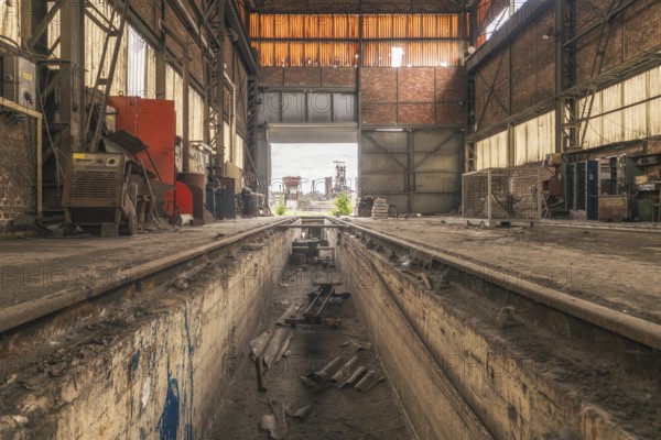 Old abandoned workshop with rails in the centre, numerous tools and rusty walls, steelworks HF4, Lost Place, Dampremy, Charleroi, Province of Hainaut, Belgium, Europe