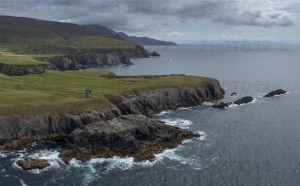 Aerial view of the rugged coastline of County Donegal at Malin Beg with the ruins of the Napoleonic signal tower on the cliff edge