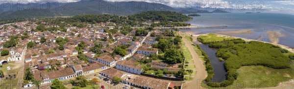 Panoramic aerial view to historic town Paraty with green mountains and sea in background on a sunny day, Unesco World Heritage, Brazil, South America