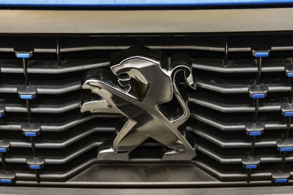 WETZLAR, Germany 2022-04-23: Peugeot logo closeup on a car grill. Peugeot as car manufacturer was founded at 1882