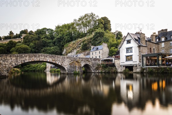 View of the medieval vridge over river Rance and the harbour of the city of Dinan, French Brittany. Long exposure