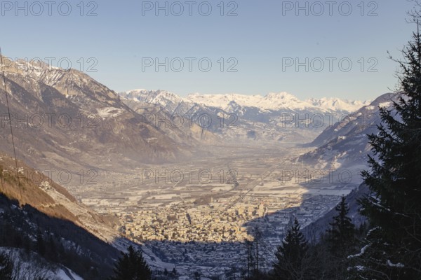 A valley town surrounded by snowy mountains at sunset, casting long shadows over the landscape, Snowy mountain, Chamonix, France, Europe