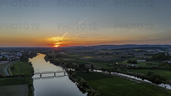 View of river and railway bridge in the light of a warm sunset, framed by fields, Danube, Bogen, Lower Bavaria