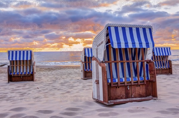 Wonderful sunrise at the beach in summer with beach chair