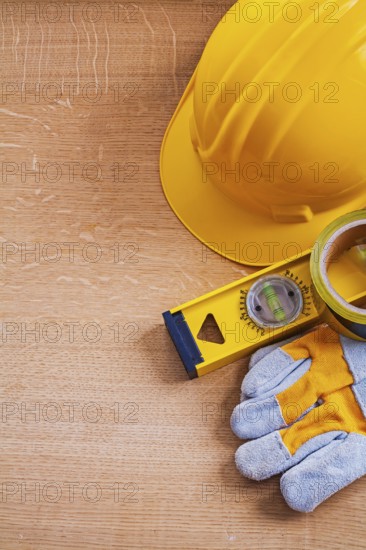 Vintage wood board with safety tools and construction level maintenance concept