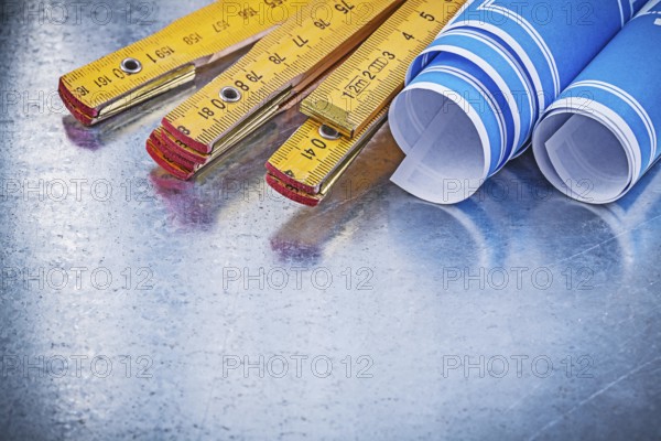 Set of blue construction drawings wooden meter on metallic background