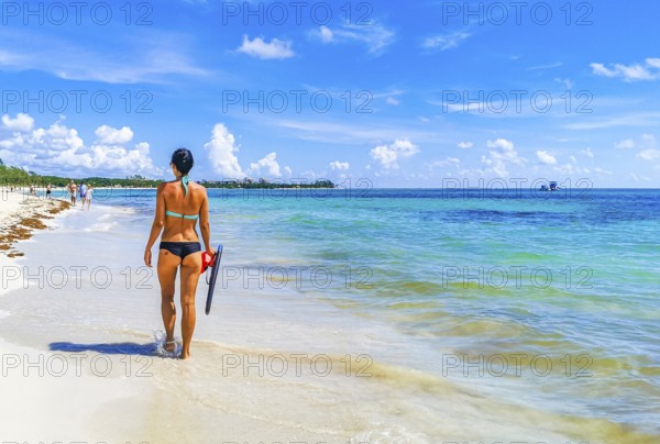 Sexy lady girl pretty woman walks on the tropical mexican beach with turquoise clear water on Playa 88 and Punta Esmeralda in Playa del Carmen Mexico