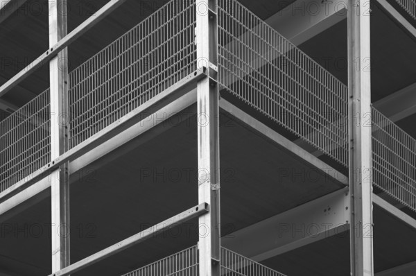 Architectural detail of a modern building highlighting steel beams and metal grids, creating a strong graphic composition