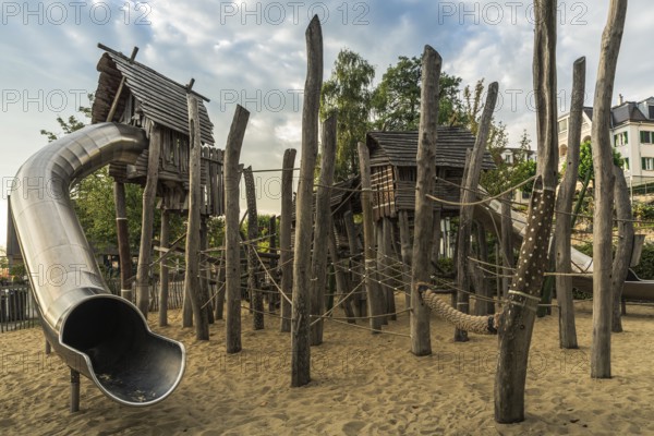 Children's playground with wooden huts, climbing equipment and slide, Bodman-Ludwigshafen, Baden-Württemberg, Germany, Europe