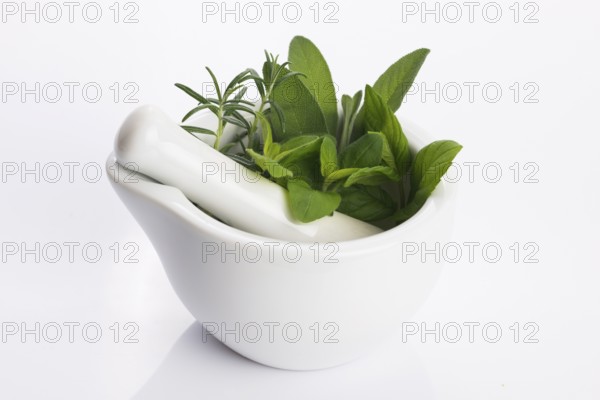 Mortar with herbs isolated on a white background