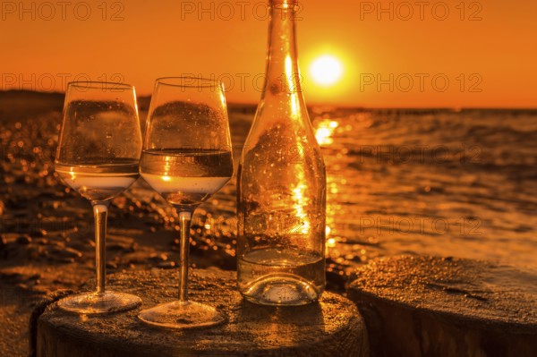 Wine on the baltic sea beach at sunset