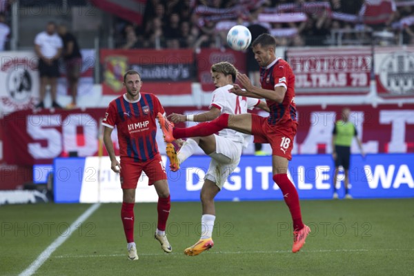 Football match, Ritsu DOAN SC Freiburg centre and Marvin PIERINGER 1. FC Heidenheim right in aerial combat for the ball, Jonas FÖHRENBACH 1. FC Heidenheim concentrates on the scene, Voith-Arena football stadium, Heidenheim