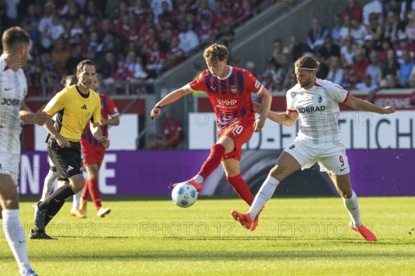 Football match, Paul WANNER 1.FC Heidenheim left in the air on the ball is disturbed by Lucas HÖLER SC Freiburg, football stadium Voith-Arena, Heidenheim
