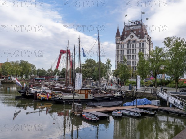 The old harbour Oudehaven with old ships and the historic skyscraper White House (Witte Huis) in Geldersekade, Rotterdam, South Holland, Netherlands