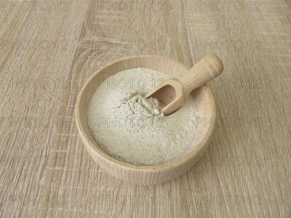 Banana flour made from green plantains in a wooden bowl
