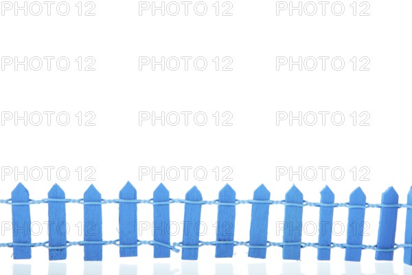 Miniature blue fence isolated over white background