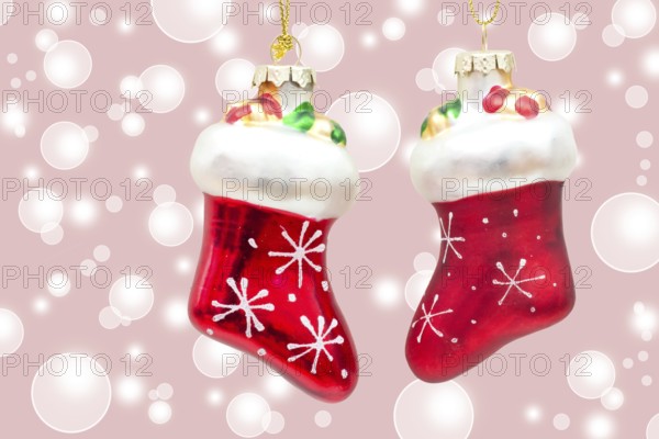 Two little red boots on pink bokeh background two little boots over pink bokeh background