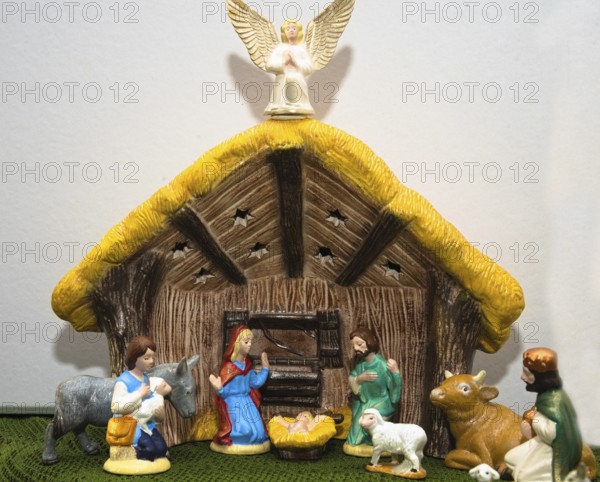 Nativity scene with painted figures of Christmas in the stable - close-up