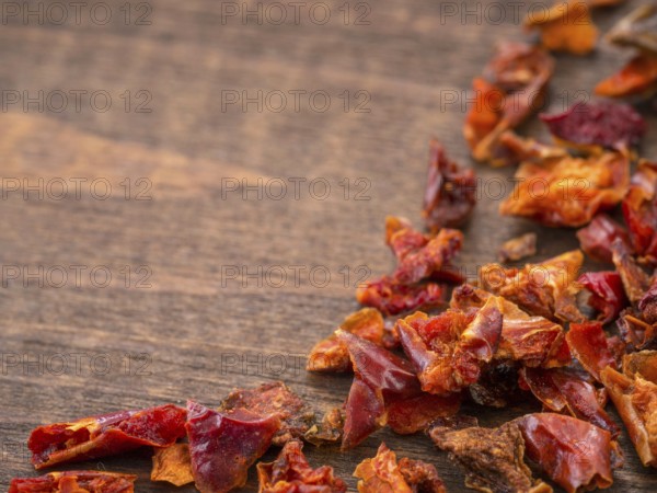 Cayenne pepper or paprika on wooden backround with copy space. Dry red pepper with copyspace