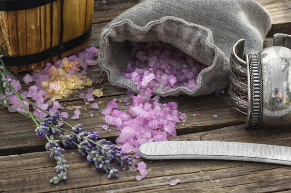 Scattered, sea salt spa treatment on wooden background