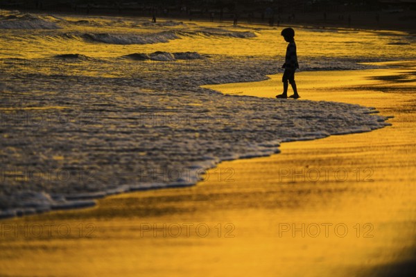 Children playing in the twilight of the beach. Shooting Location: Kamakura, Kanagawa Prefecture