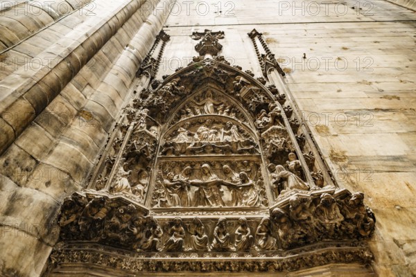 Relief on a religious theme on the wall in the Duomo. Milan, Italy.