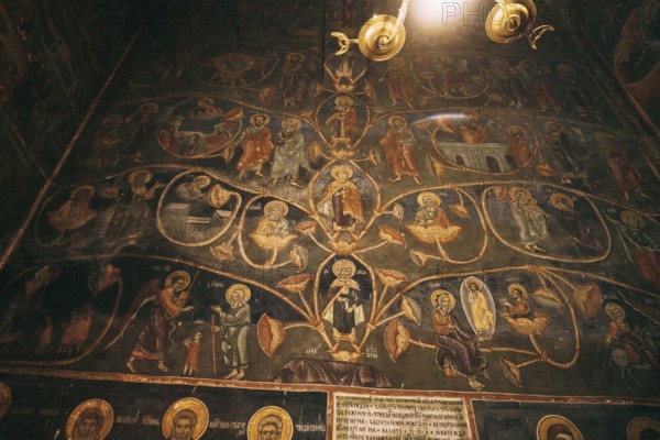 Church wall with paintings from the lives of the saints.