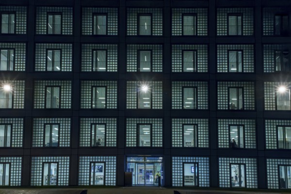 Night shot of the façade with entrance door and countless windows of the cube-shaped city library on Mailänder Platz by architect Prof. Eun Young Yi, Stuttgart, Baden-Württemberg, Germany, Europe