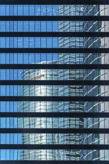 Office building and reflections against blue sky. Business and finance concept