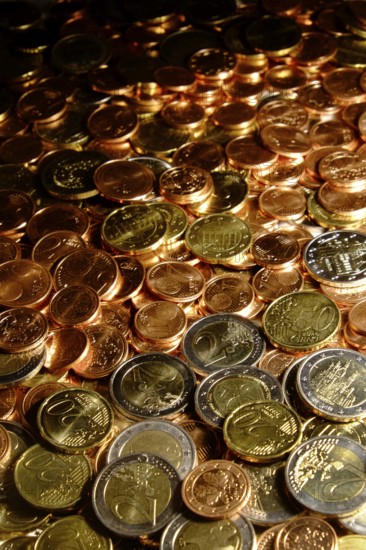 Euro coins of all denominations fill the motif. Portrait format. Euros of all coin values fill in the hole picture. Vertical format