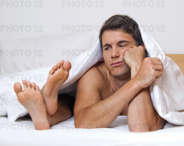 A young couple in bed having problems and crisis. Divorce and separation, A young couple in bed having problems and crisis. Divorce and separation. Austria