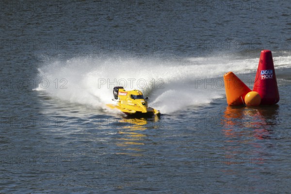 PESO DA REGUA, PORTUGAL - SEPTEMBER 15, 2024: Yellow Powerboat Makes Sharp Turn with Splashes of Water during Race. Red Buoy. Formula 2 World Championship