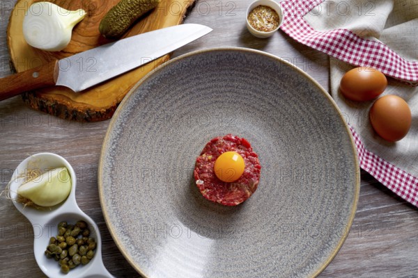 Steak Tartare raw meat recipe with egg yolk modern cuisine