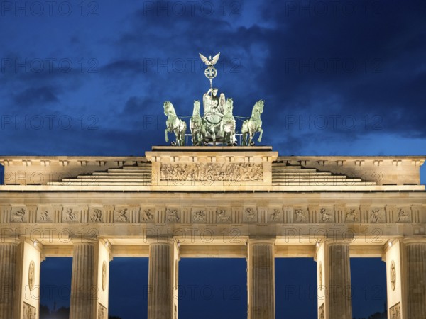 Symmetrical night shot of the Brandenburg Tor, majestically illuminated, Berlin, Germany, Europe