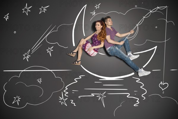 Happy valentines love story concept of a romantic couple fishing on a moon with a heart on a hook against chalk drawings background