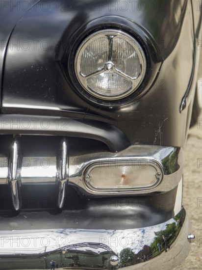 Close-up of a black classic car with focus on the headlights and chrome, Duisburg, Ruhr area, Germany, Europe