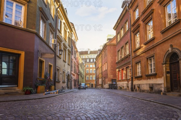 Narrow street of Old Town in Warsaw at sunrise