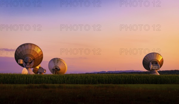 Large parabolic antenna at dusk