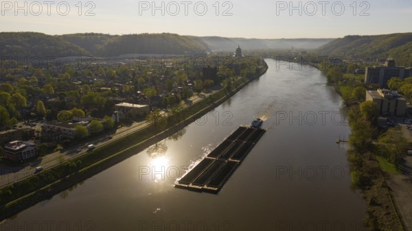 Charleston West Virgina ia an active seaport here a barge moves coal around