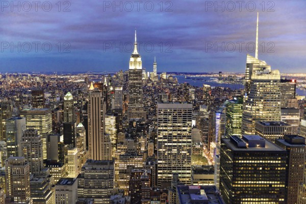 Rockefeller Center observation deck, panoramic view of the dense New York City skyline, lights of the New York metropolis illuminate the city under a purple night sky, Manhattan, New York City, New York, USA, North America