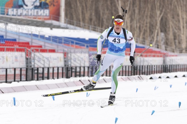 Sportsman biathlete Zlobin Vladislav Khanty-Mansiysk skiing on distance biathlon stadium. Open regional youth biathlon competitions East Cup. Kamchatka Peninsula, Russian Far East, April 12, 2019