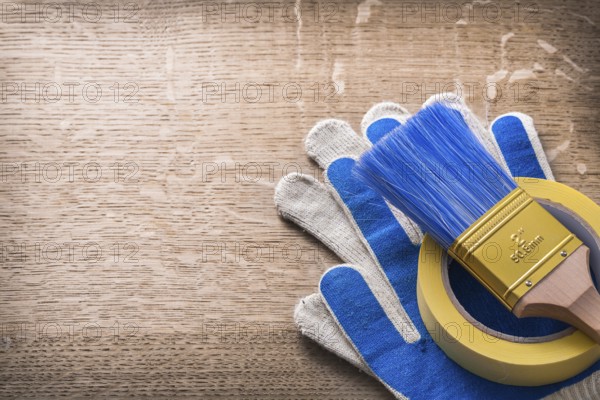 Safety gloves paint brush adhesive tape construction concept