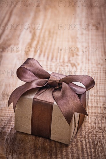 Single vintage gift box on old wooden board