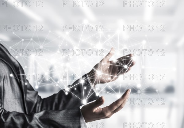 Business woman in suit keeping white social media network structure in hands with office view on background. Mixed media
