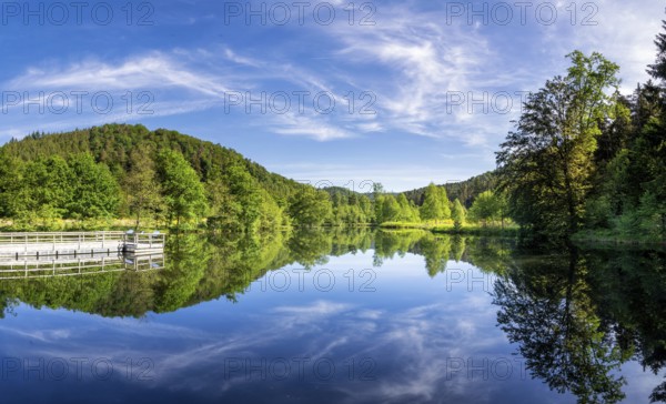 Beautiful reflection of a lake in the Spiesswoogtal valley near the German village Fischbach bei Dahn in the Rhineland-Palatinate